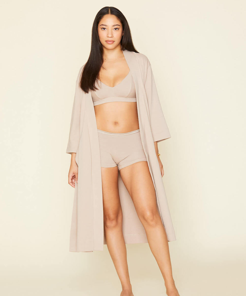 Woman wearing the essential robe in stone beige color