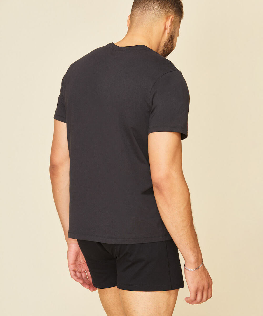 Man wearing the men's classic tee in graphite gray color.
