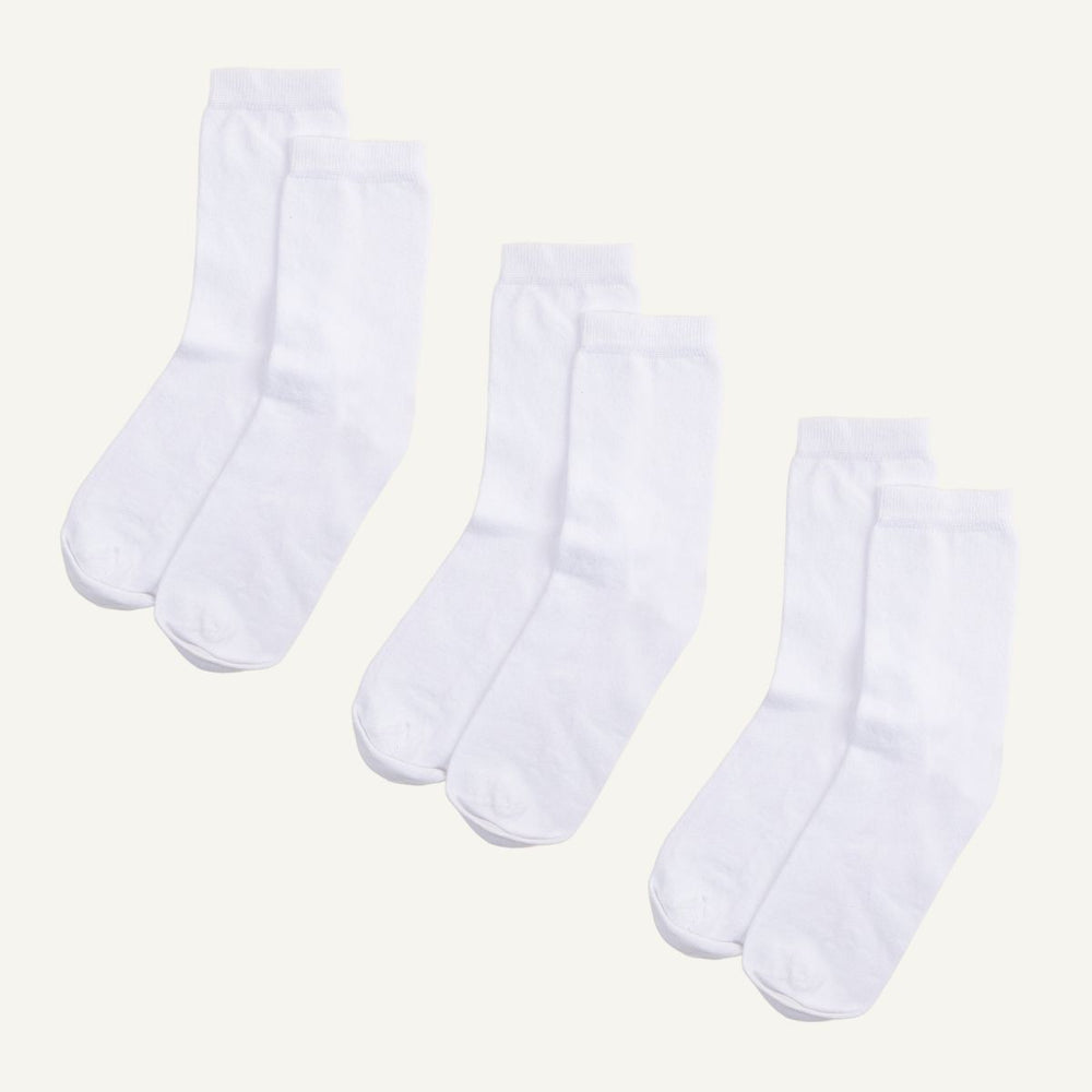 Three pairs of white organic cotton crew socks.
